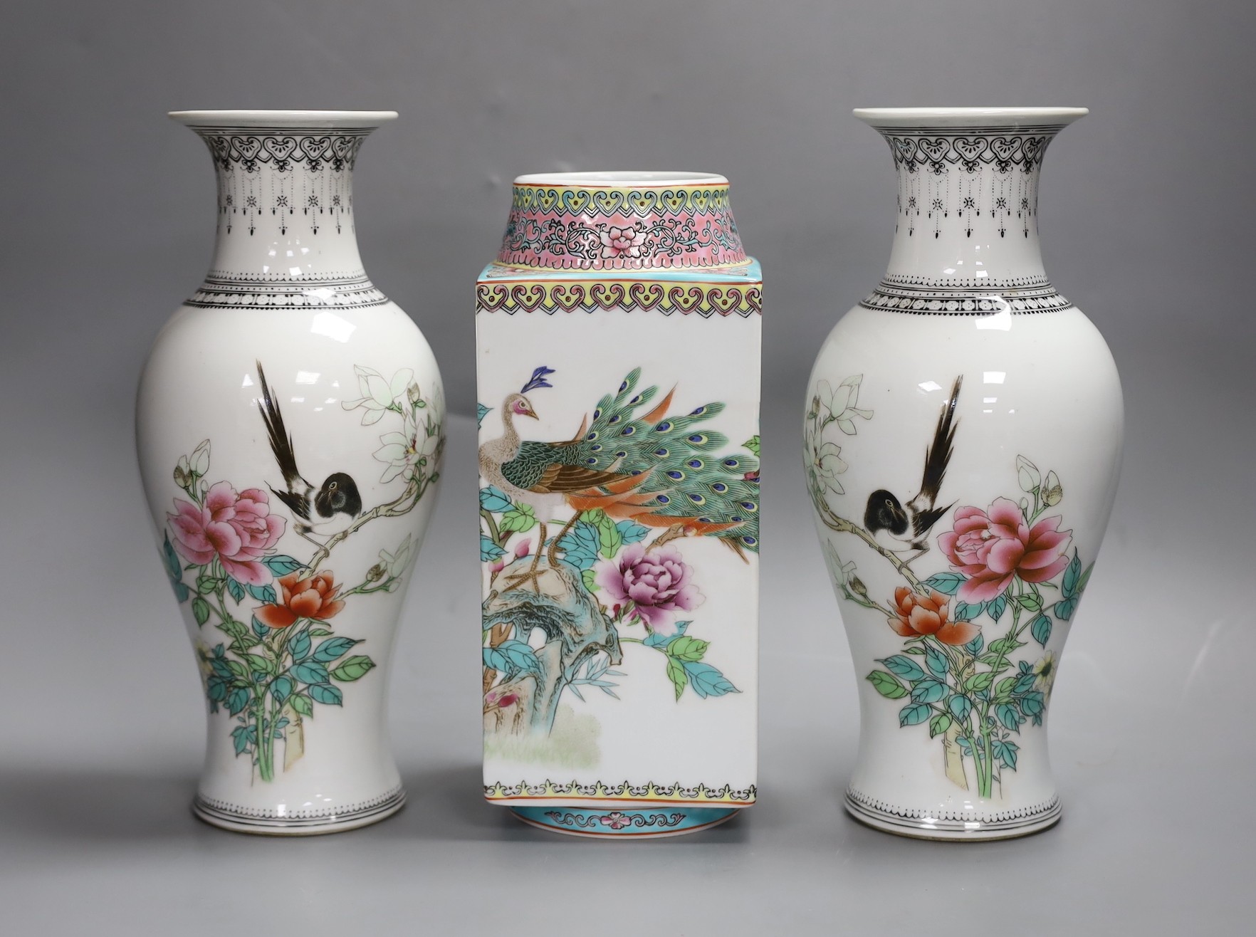 A pair of early Chinese famille rose vases and another similar, Republic period, tallest 26cm